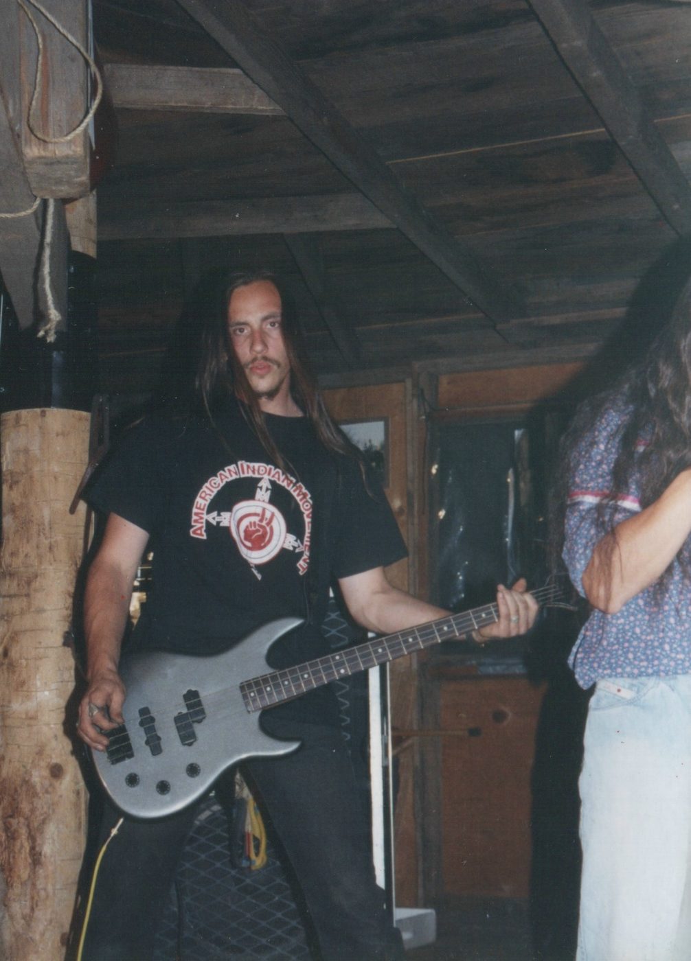 Micah Owens playing bass in an earlier band